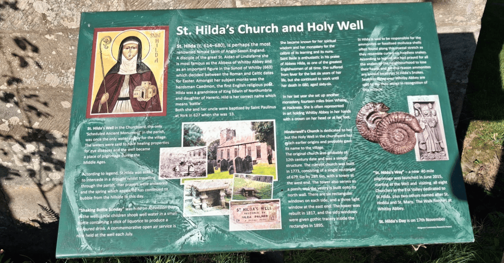 Information board about St. Hilda's Church and Holy Well, detailing historical significance, legends, and events associated with Saint Hilda.