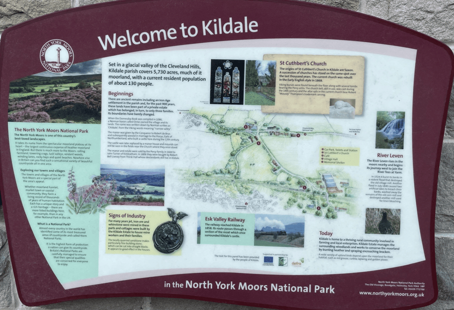 Information board about Kildale, located in the North York Moors National Park, highlighting its history, population, and attractions such as St Cuthbert's Church and the River Leven.